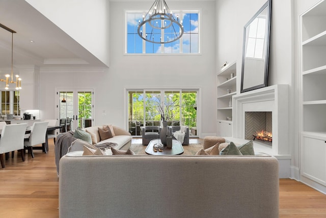 9316 Edenwilde Dr, Brentwood, TN 37027 - living area with an inviting chandelier, a warm lit fireplace, a healthy amount of sunlight, and crown molding