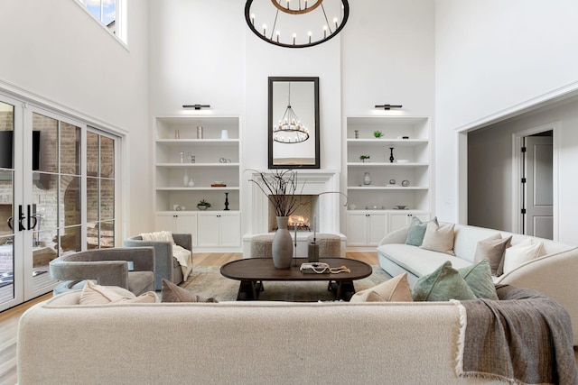 9316 Edenwilde Dr, Brentwood, TN 37027 - living room featuring a notable chandelier, light wood finished floors, and a high ceiling