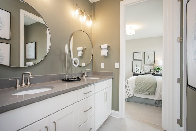 5963 Hunt Valley Dr, Spring Hill, TN 37174 - ensuite bathroom with tile patterned floors, double vanity, and baseboards