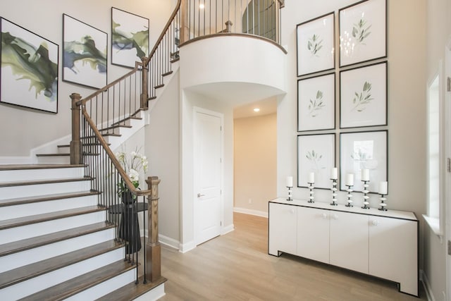 5963 Hunt Valley Dr, Spring Hill, TN 37174 - stairs featuring a high ceiling, wood finished floors, arched walkways, and baseboards