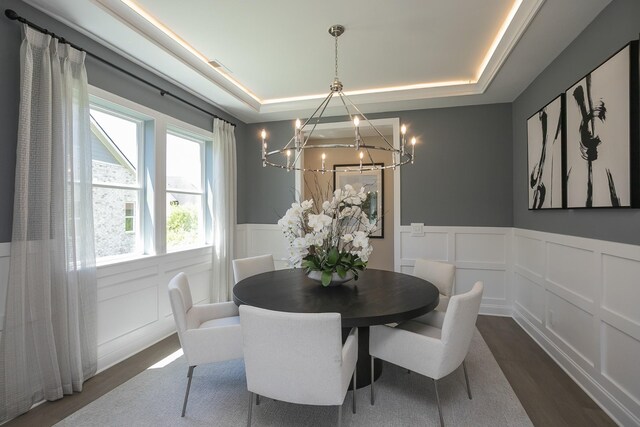 5963 Hunt Valley Dr, Spring Hill, TN 37174 - dining room featuring a decorative wall, a chandelier, a raised ceiling, dark wood-style floors, and a wainscoted wall