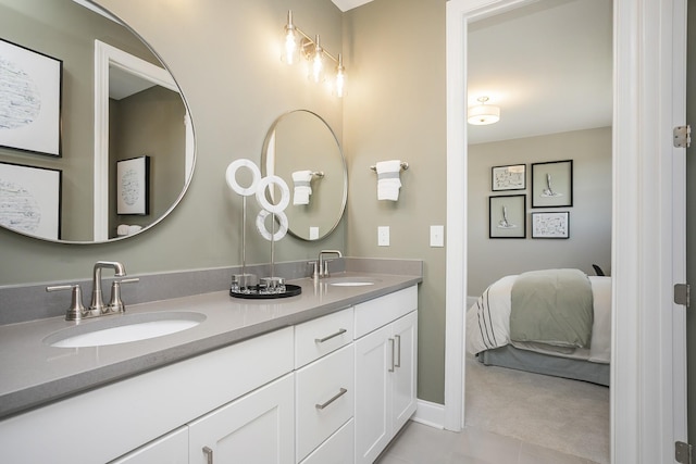 5963 Hunt Valley Dr, Spring Hill, TN 37174 - ensuite bathroom featuring double vanity, tile patterned flooring, and baseboards