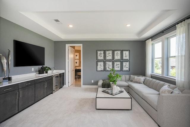 5963 Hunt Valley Dr, Spring Hill, TN 37174 - living room featuring a tray ceiling, beverage cooler, light carpet, baseboards, and recessed lighting