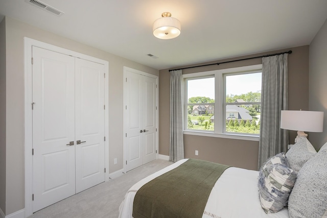 5963 Hunt Valley Dr, Spring Hill, TN 37174 - bedroom featuring two closets, light colored carpet, and baseboards