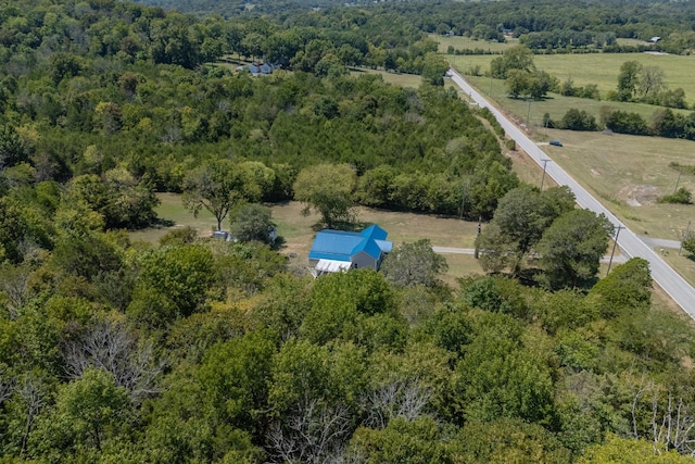 drone / aerial view featuring a rural view and a wooded view