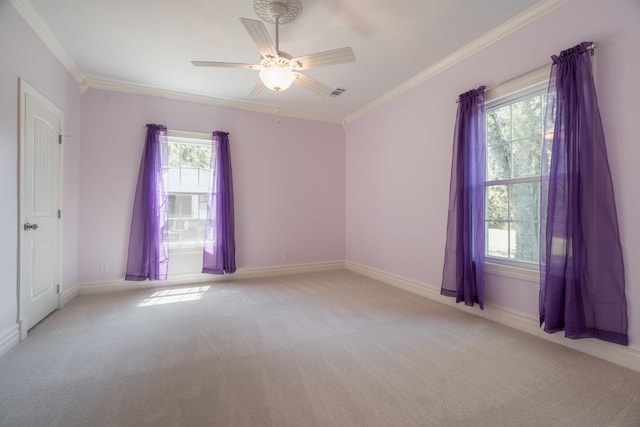 spare room featuring baseboards, ornamental molding, ceiling fan, and light colored carpet