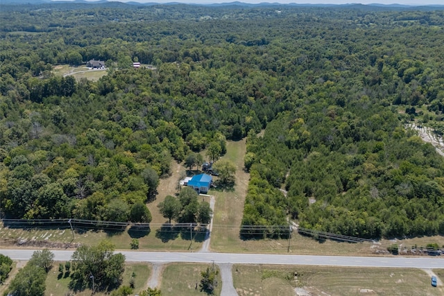 birds eye view of property featuring a mountain view and a wooded view