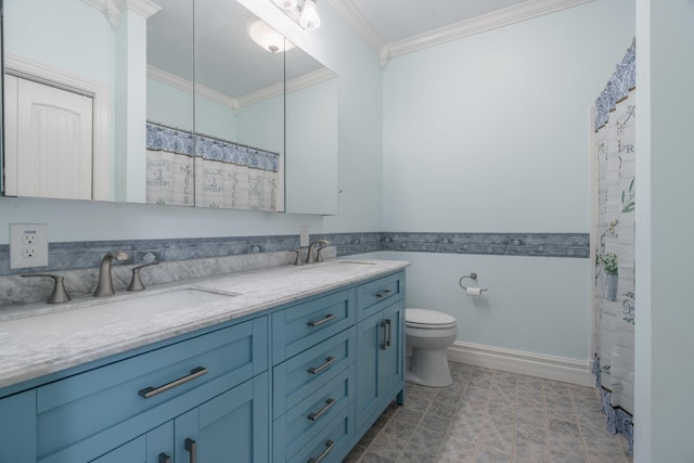 full bath featuring toilet, ornamental molding, double vanity, and a sink