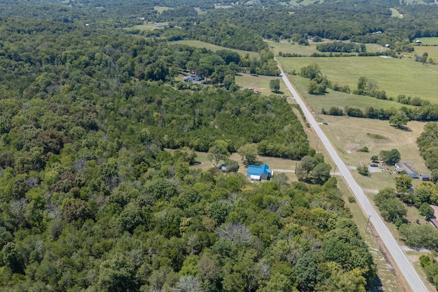 birds eye view of property featuring a forest view