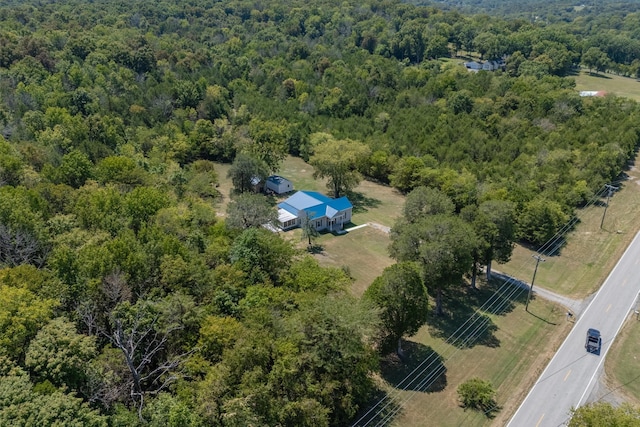 birds eye view of property with a forest view