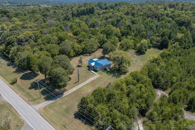birds eye view of property featuring a view of trees