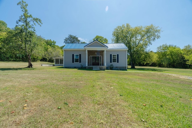 bungalow-style house featuring a front lawn, a sunroom, crawl space, and metal roof