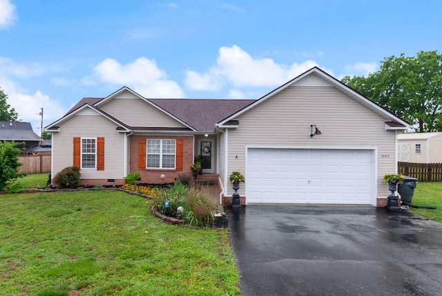 ranch-style home featuring a front lawn, driveway, fence, and a garage