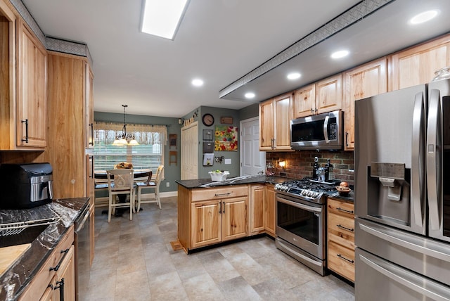 kitchen featuring a peninsula, dark countertops, stainless steel appliances, light brown cabinets, and backsplash
