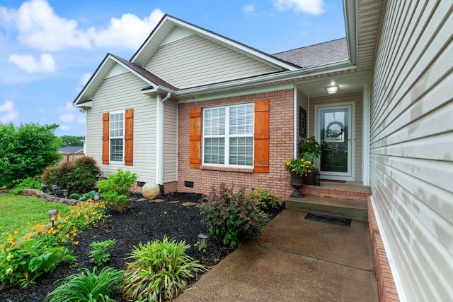property entrance with brick siding