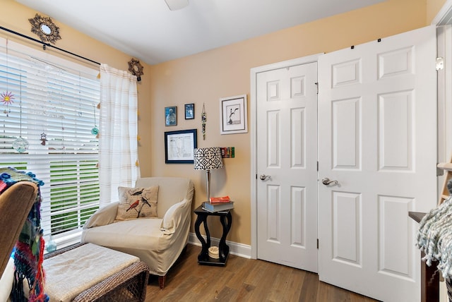 sitting room featuring baseboards and wood finished floors