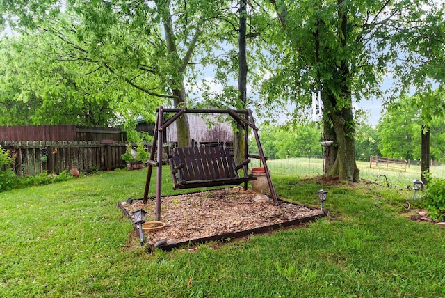 view of jungle gym featuring a yard and fence private yard