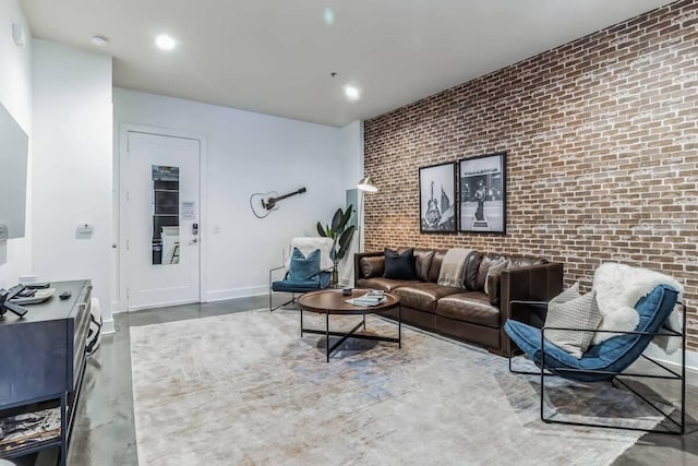 210 30th Ave N Unit 207, Nashville, TN 37203 - living area featuring concrete flooring, recessed lighting, an accent wall, brick wall, and baseboards