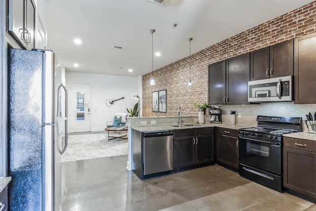 210 30th Ave N Unit 207, Nashville, TN 37203 - kitchen featuring visible vents, a sink, a peninsula, finished concrete floors, and stainless steel appliances