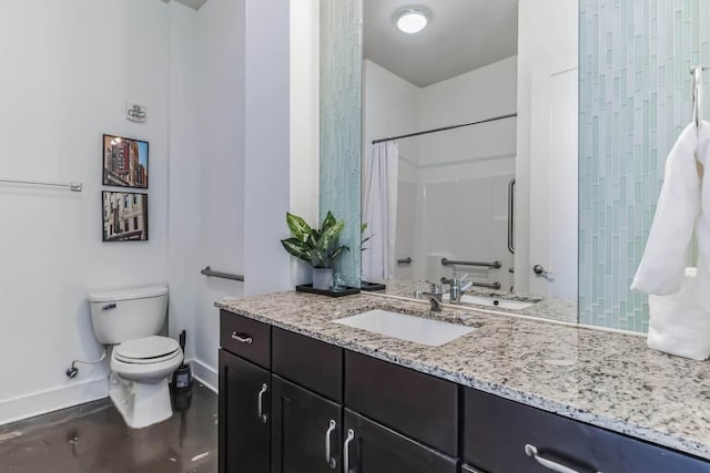 210 30th Ave N Unit 207, Nashville, TN 37203 - full bathroom featuring baseboards, vanity, toilet, and a shower with shower curtain