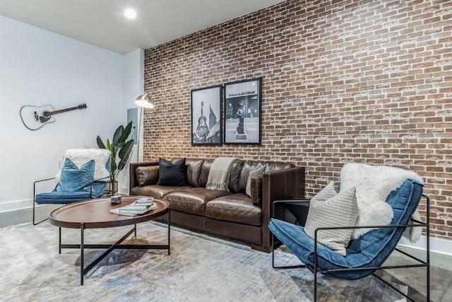 210 30th Ave N Unit 207, Nashville, TN 37203 - living room featuring brick wall and baseboards