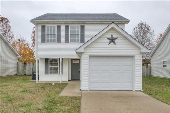 traditional-style house featuring fence, concrete driveway, central AC, and a front yard