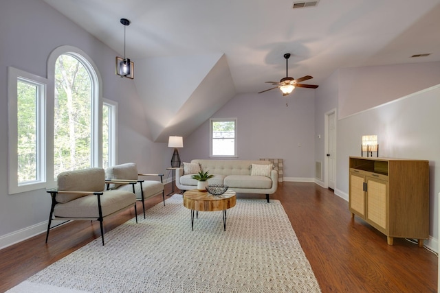living area featuring lofted ceiling, baseboards, a ceiling fan, and wood finished floors