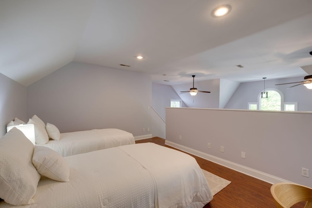 bedroom featuring lofted ceiling, baseboards, ceiling fan, and wood finished floors