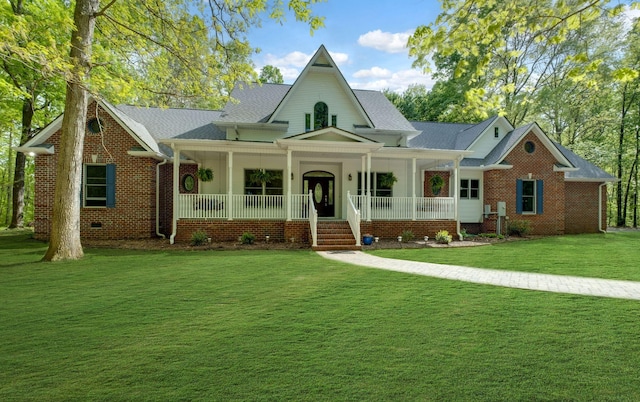 view of front of home featuring a porch, brick siding, and a front yard
