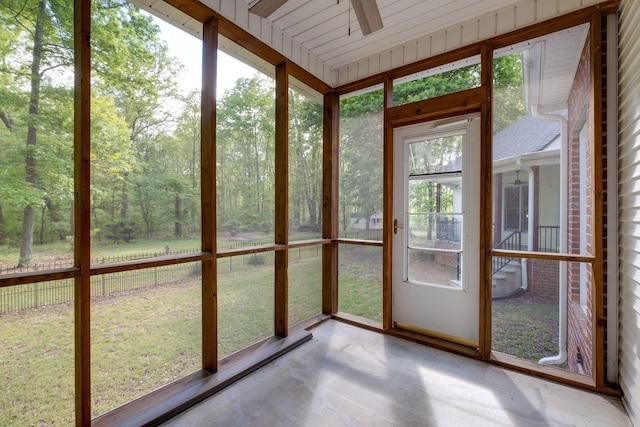 unfurnished sunroom with ceiling fan