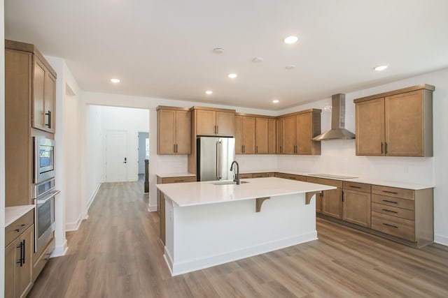 126 W Cassa Way, Mount Juliet, TN 37122 - kitchen featuring light wood-style floors, wall chimney exhaust hood, stainless steel appliances, and a sink