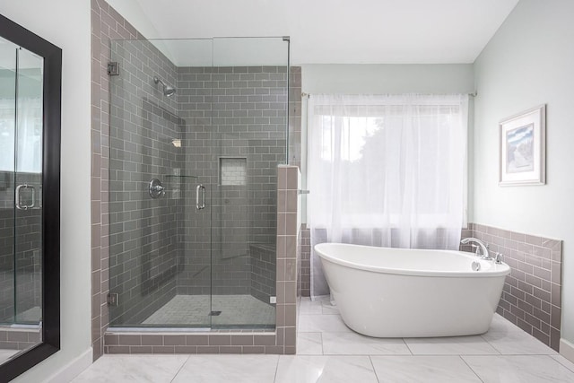 bathroom with a soaking tub and a stall shower