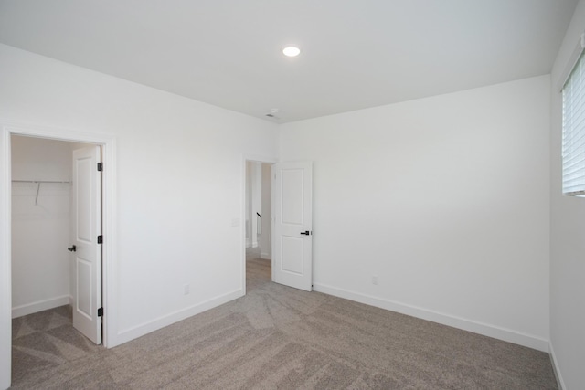132 W Cassa Way, Mount Juliet, TN 37122 - unfurnished bedroom with a walk in closet, light carpet, baseboards, and recessed lighting