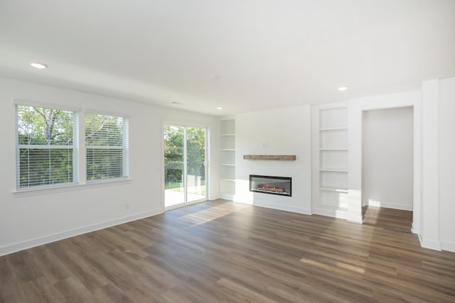 132 W Cassa Way, Mount Juliet, TN 37122 - unfurnished living room with wood finished floors, recessed lighting, built in shelves, baseboards, and a glass covered fireplace