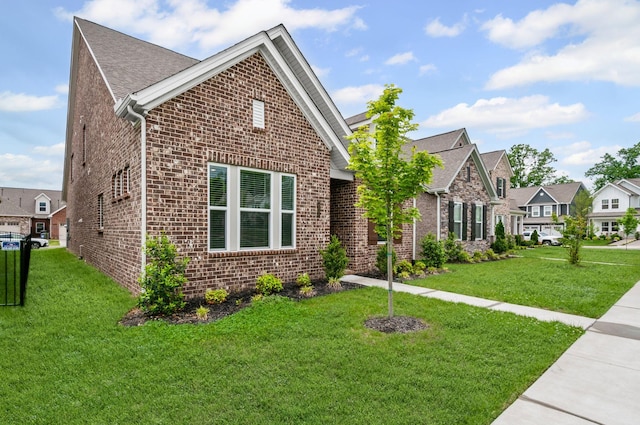 2131 Gunwale Mews, Franklin, TN 37064 - view of front of home featuring brick siding, a front lawn, a residential view, and roof with shingles