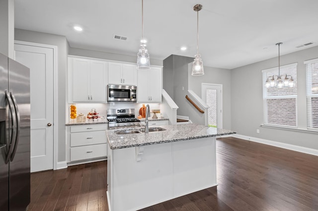 2131 Gunwale Mews, Franklin, TN 37064 - kitchen featuring stainless steel appliances, a sink, dark wood-style floors, white cabinets, and light stone counters