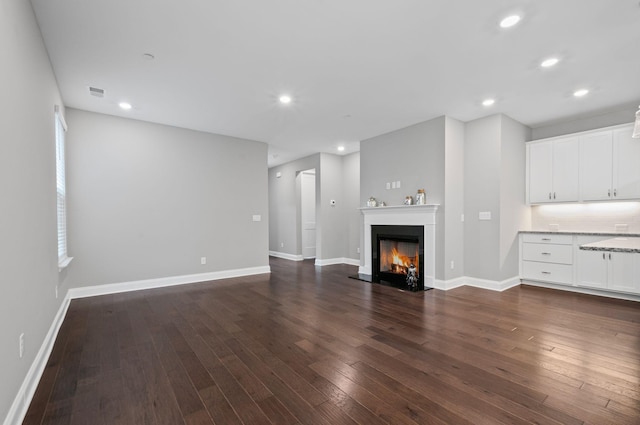 2131 Gunwale Mews, Franklin, TN 37064 - unfurnished living room with dark wood-type flooring, recessed lighting, baseboards, and a lit fireplace