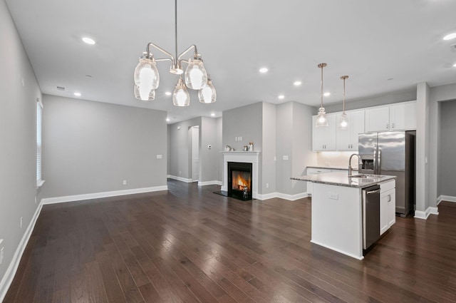 2131 Gunwale Mews, Franklin, TN 37064 - kitchen featuring open floor plan, a kitchen island with sink, light stone countertops, stainless steel appliances, and baseboards