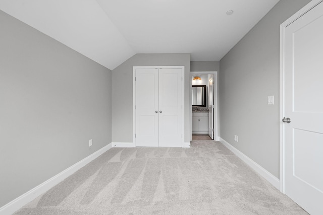 2131 Gunwale Mews, Franklin, TN 37064 - unfurnished bedroom featuring baseboards, light colored carpet, lofted ceiling, ensuite bathroom, and a closet