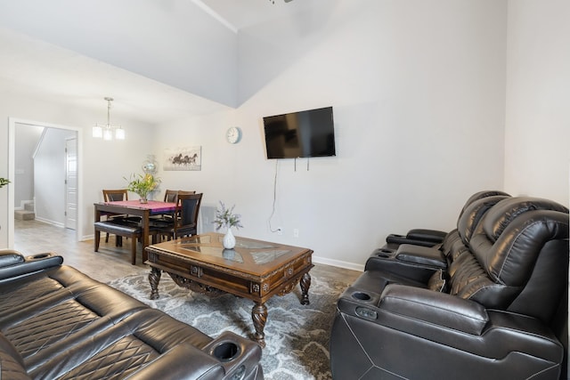 living area with baseboards and a notable chandelier