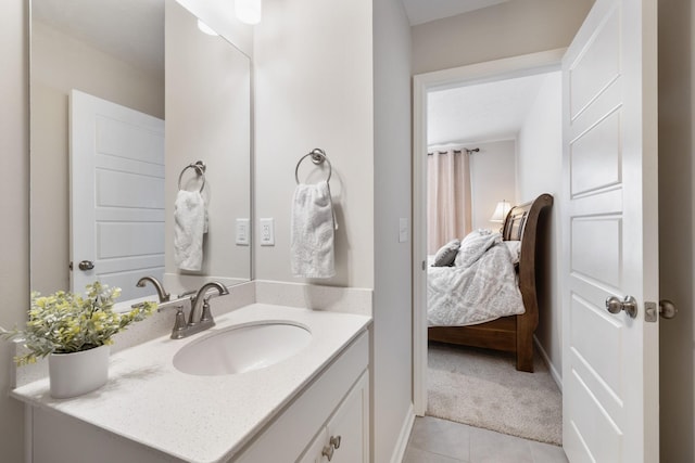 bathroom featuring vanity, connected bathroom, baseboards, and tile patterned floors