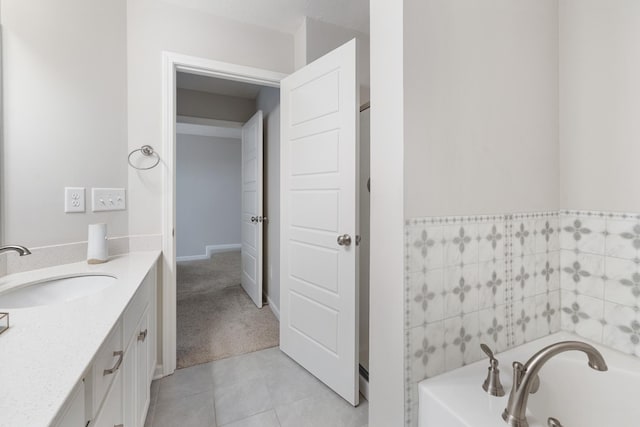 full bathroom featuring tile patterned floors, a bath, and vanity