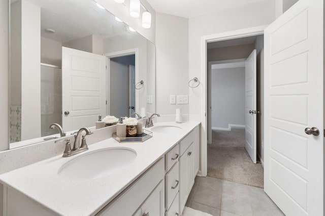 full bathroom featuring a sink, double vanity, an enclosed shower, and tile patterned floors