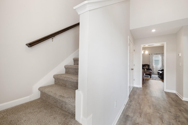 stairs with recessed lighting, baseboards, and wood finished floors