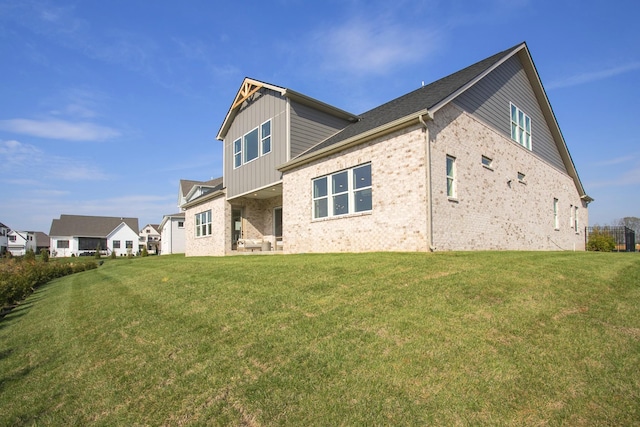 5961 Hunter Valley Dr, Spring Hill, TN 37174 - back of house with brick siding, a yard, and board and batten siding