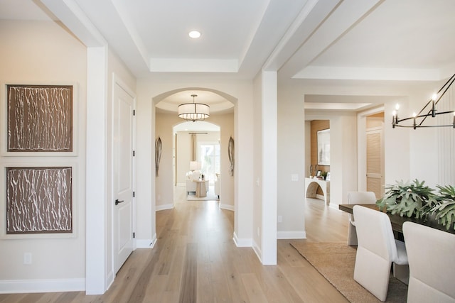 5961 Hunter Valley Dr, Spring Hill, TN 37174 - corridor featuring arched walkways, a chandelier, a raised ceiling, light wood-style floors, and recessed lighting