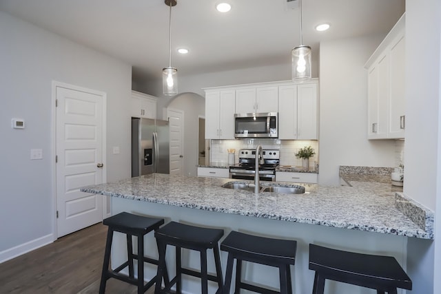 2804 Sonoma Way, Columbia, TN 38401 - kitchen with a peninsula, stainless steel appliances, arched walkways, and white cabinets