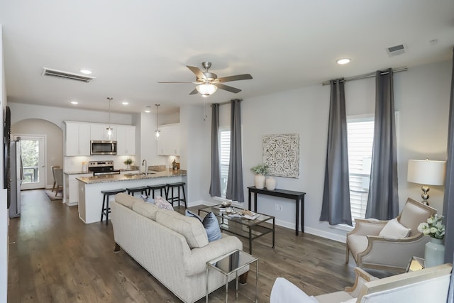 2804 Sonoma Way, Columbia, TN 38401 - living area with arched walkways, ceiling fan, visible vents, and dark wood-style flooring