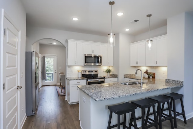 2804 Sonoma Way, Columbia, TN 38401 - kitchen with a sink, a peninsula, visible vents, arched walkways, and appliances with stainless steel finishes