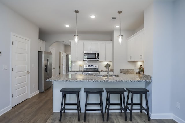 2804 Sonoma Way, Columbia, TN 38401 - kitchen featuring a sink, a peninsula, arched walkways, backsplash, and stainless steel appliances